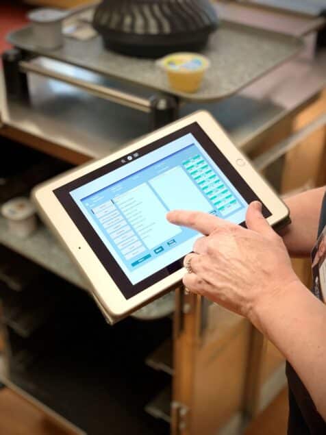 A tablet demonstrates menu offerings at gritman medical center