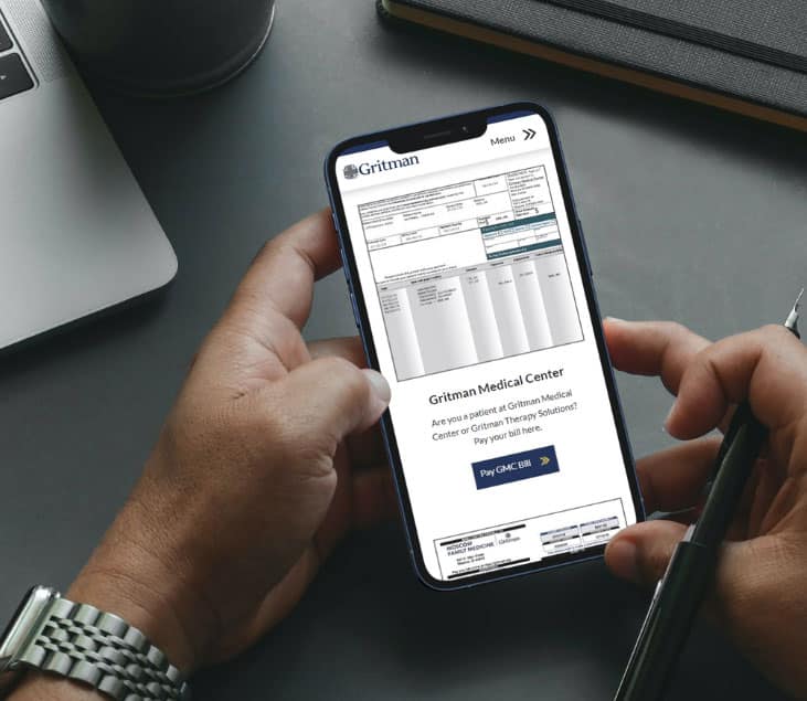 Holding a mobile phone with Gritman billing information